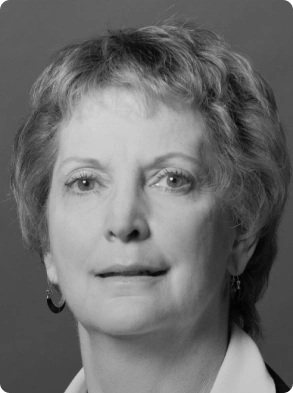 Professional black and white headshot of woman with short hair and earrings