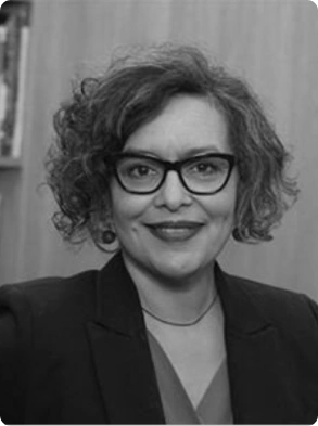 Professional black and white headshot of woman wearing glasses and blazer