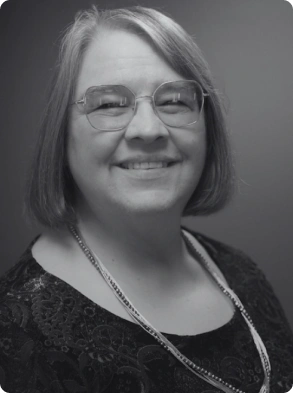 Corporate portrait featuring female professional with necklace and patterned top