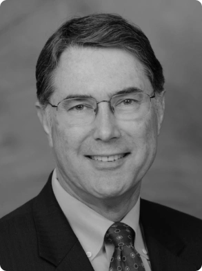 Black and white professional headshot featuring smiling male executive